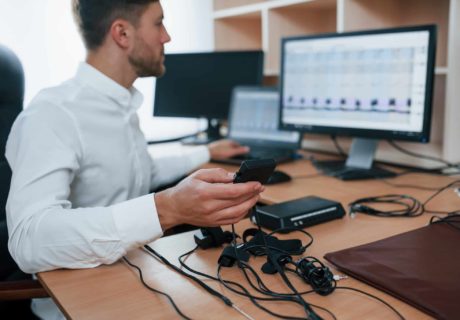 Testing device. Polygraph examiner works in the office with his lie detector's equipment.