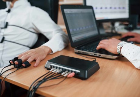 Work in progress. Suspicious man passes lie detector in the office. Asking questions. Polygraph test.